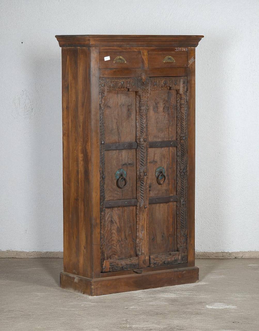 Discover timeless craftsmanship with the Timber Crown Almirah, handcrafted from solid teak wood. Featuring antique-style doors with carved details and iron ring handles