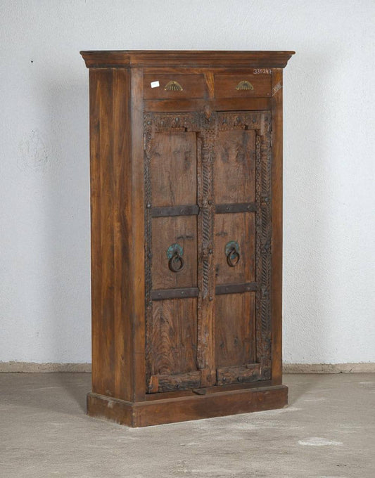 Discover timeless craftsmanship with the Timber Crown Almirah, handcrafted from solid teak wood. Featuring antique-style doors with carved details and iron ring handles