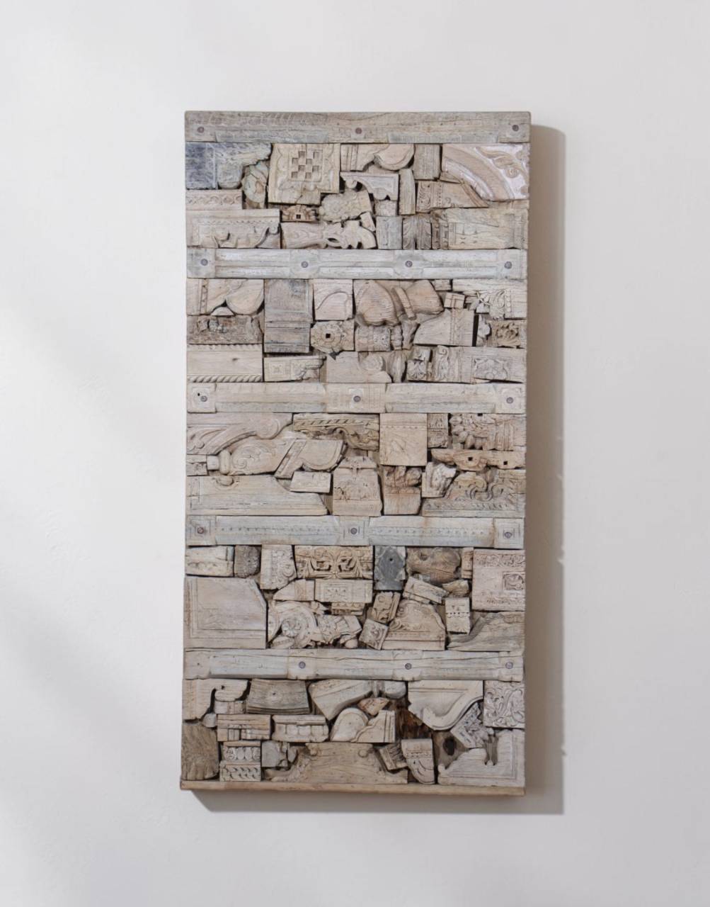 Unique mosaic design made from salvaged carved wood fragments.