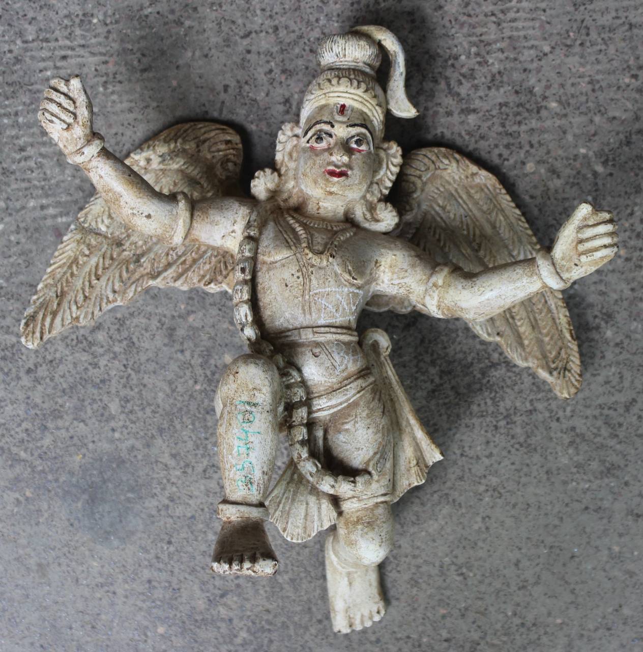 Statue of a winged figure on a gray background