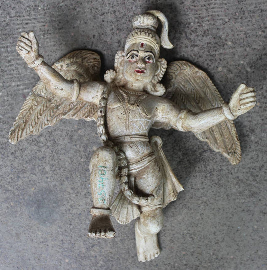 Statue of a winged figure on a gray background