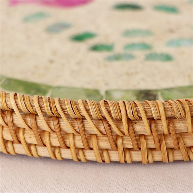 Enhance your Dream Home with our curated selection of premium Home Décor items. Round Mother Of Pearl Rattan Tray is made with handwoven rattan material mixed mother of pearl Impress your guests with these beautiful hand woven serving trays made with natural Rattan. In effortlessly chic hand-woven round tray has a designer motifs on it which makes it a center of attraction. TESU