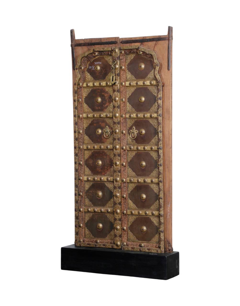 A traditional Moroccan leather door panel with brass hardware, mounted on a black wooden base, shown against a plain white background.