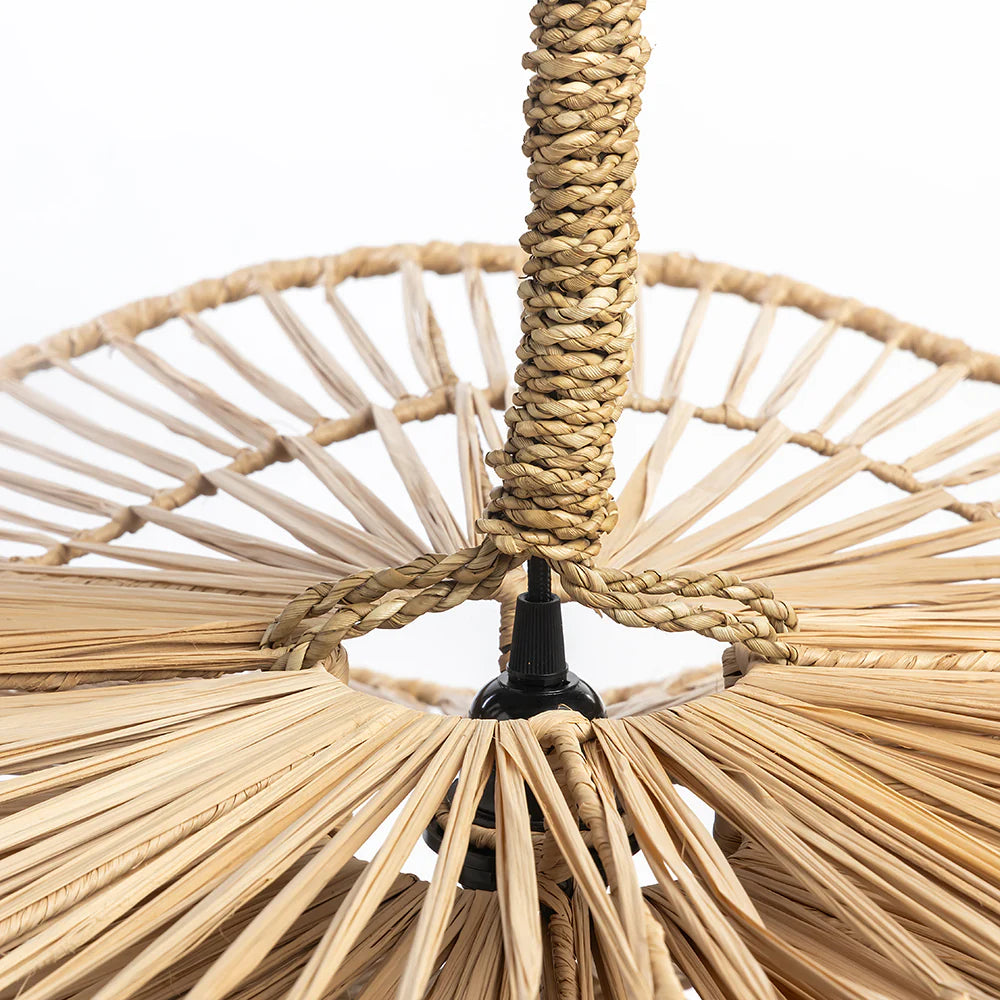 Close-up of a woven natural light fixture with a white background