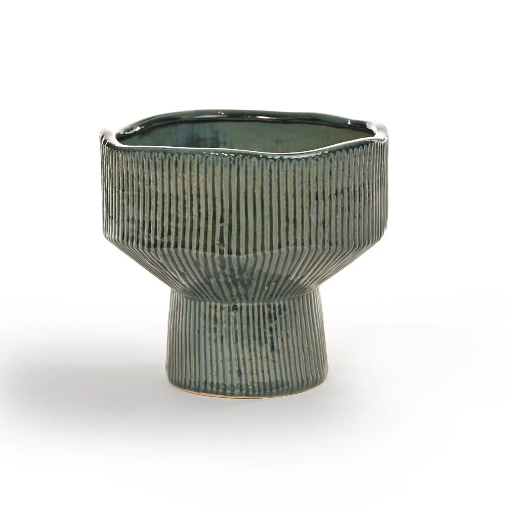 Its unique silhouette, defined by clean lines and vertical ridges, draws inspiration from natural rock formations and mid-century design.