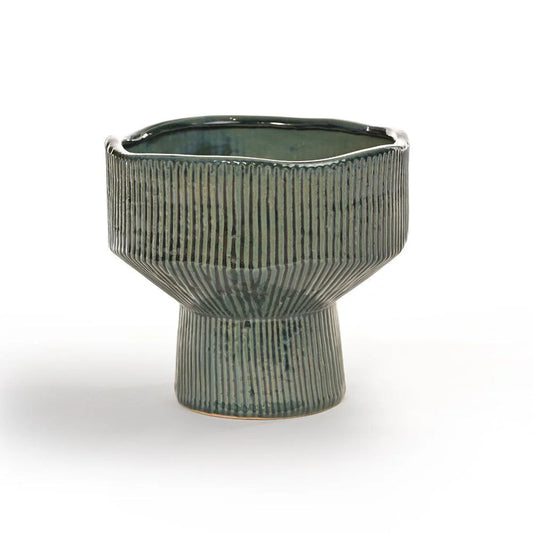 Its unique silhouette, defined by clean lines and vertical ridges, draws inspiration from natural rock formations and mid-century design.