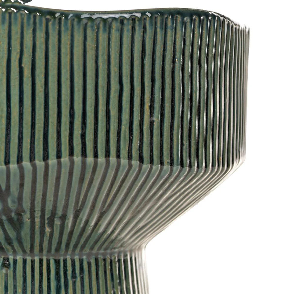 Close-up of a textured ceramic bowl with ribbed design on a white background
