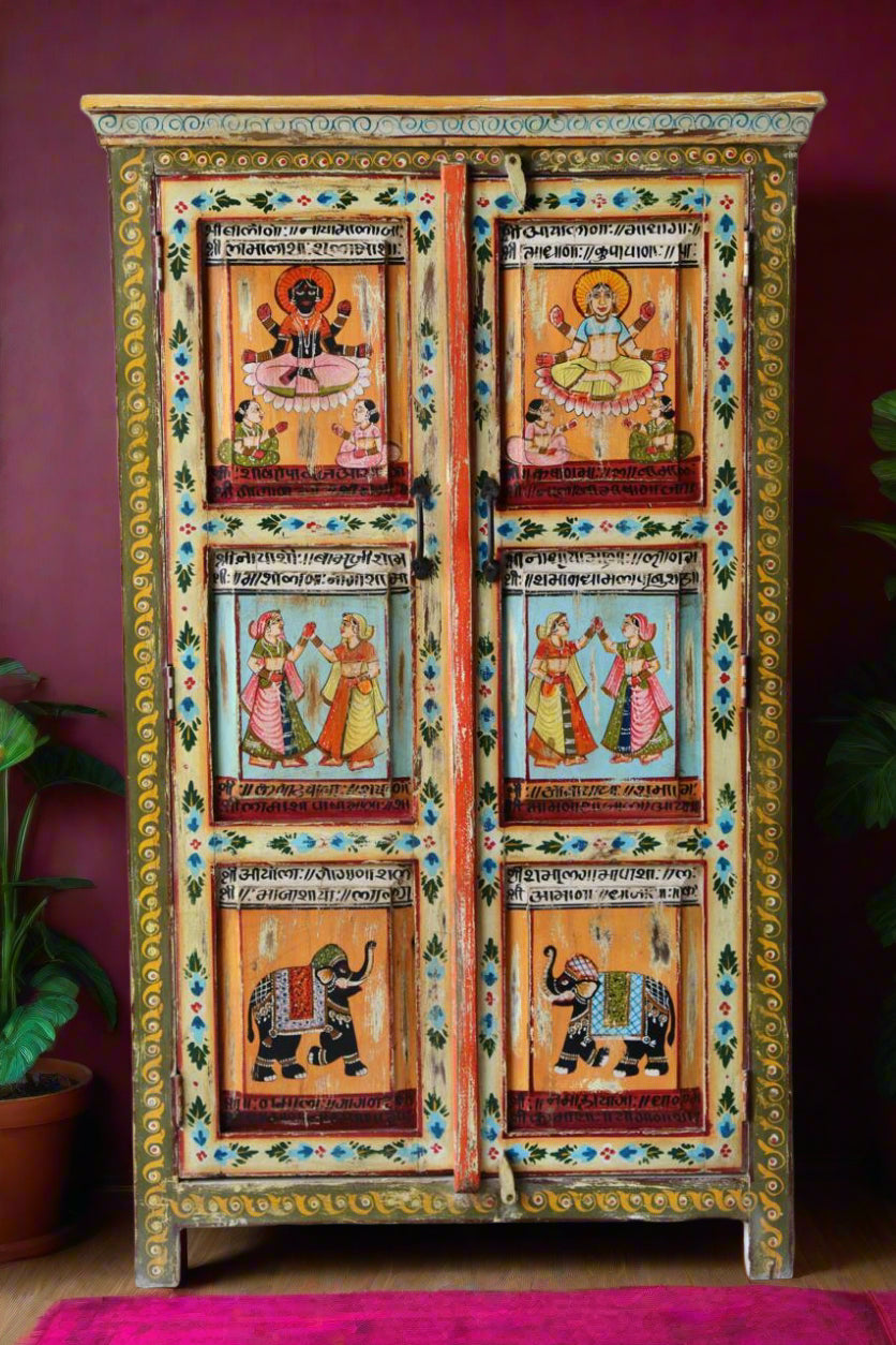 Decorative cabinet with painted designs on a white brick wall background