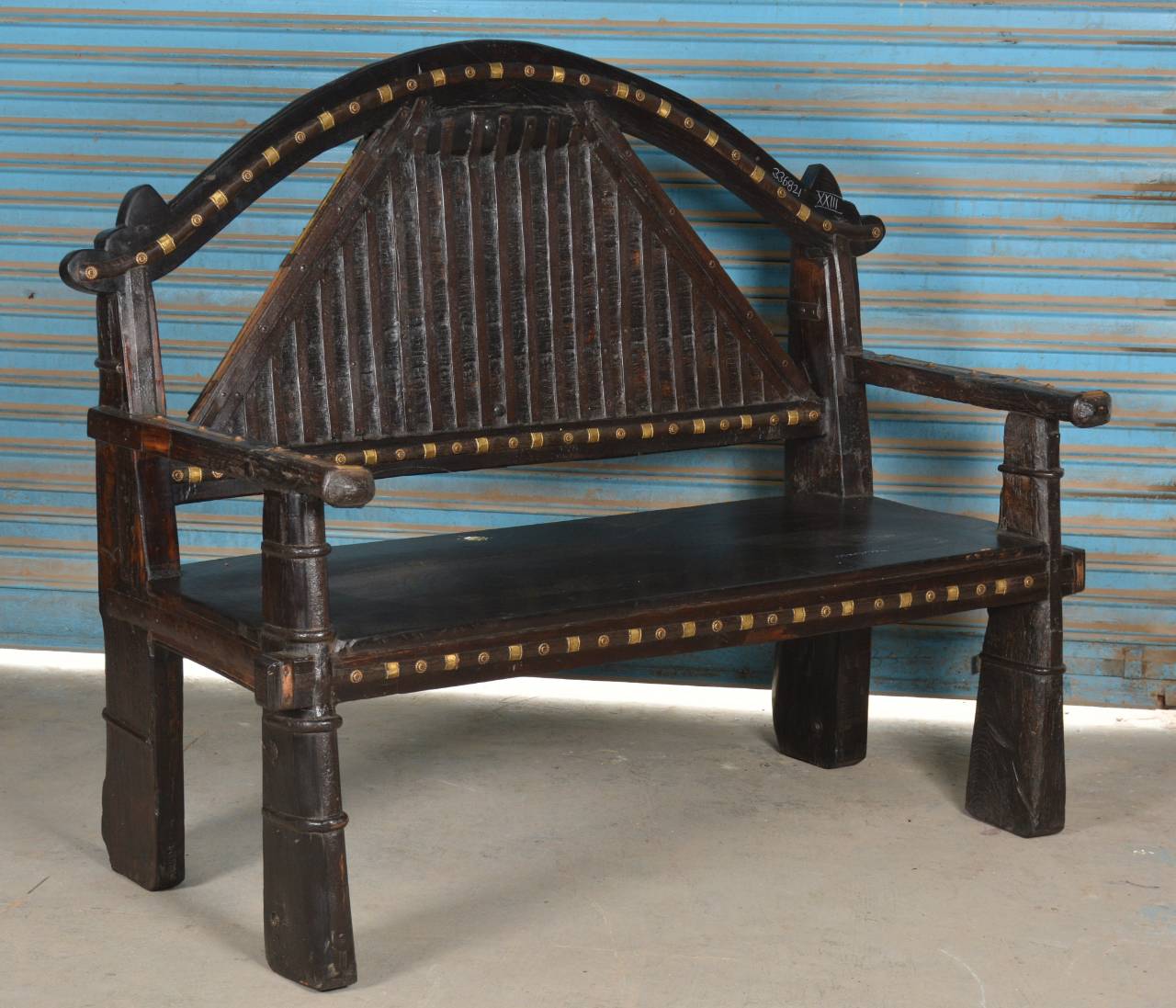 This unique bench features a gracefully arched backrest, traditional design elements, and robust construction—making it both functional and decorative.