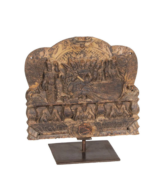 Crafted meticulously from aged teak wood and mounted on a sturdy iron base, the piece radiates mythological grandeur and artisanal mastery. 