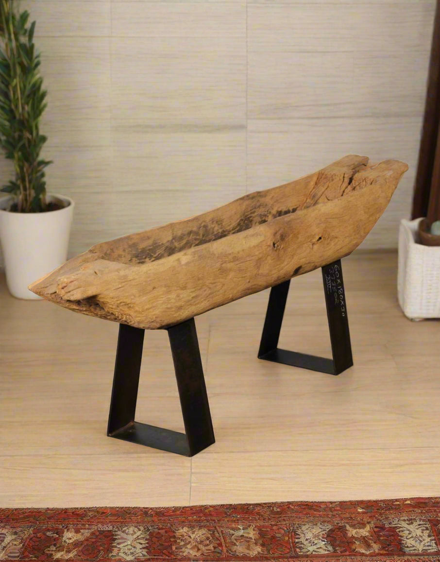 The Wood Cycle Planter is sculpted from recycled wood and elevated on an industrial iron base, blending raw nature with refined design. 