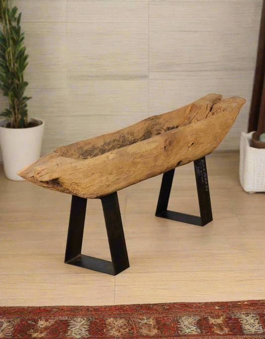 The Wood Cycle Planter is sculpted from recycled wood and elevated on an industrial iron base, blending raw nature with refined design. 