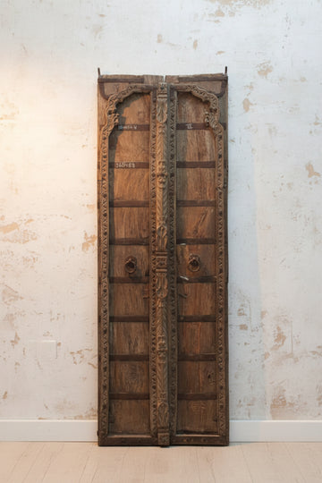 Add a touch of elegance and traditional charm to your home decor with our Wooden Carved Door Panel. Made of high-quality Teak Wood with intricate iron work,