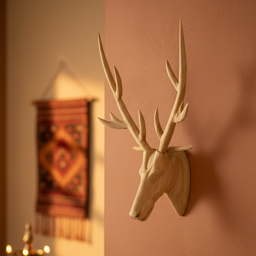 Wooden deer head with large antlers on a white background