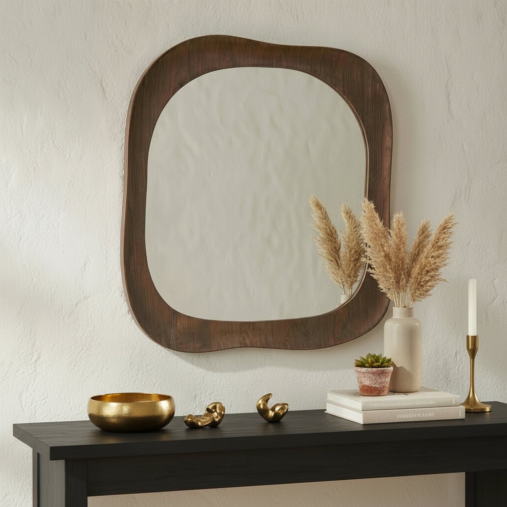 Wooden console table with decorative items and a large wooden-framed mirror on a textured wall.