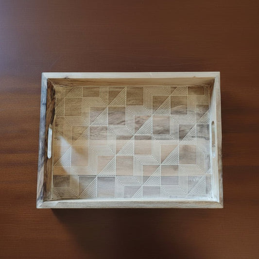 Wooden tray with geometric pattern on a wooden surface