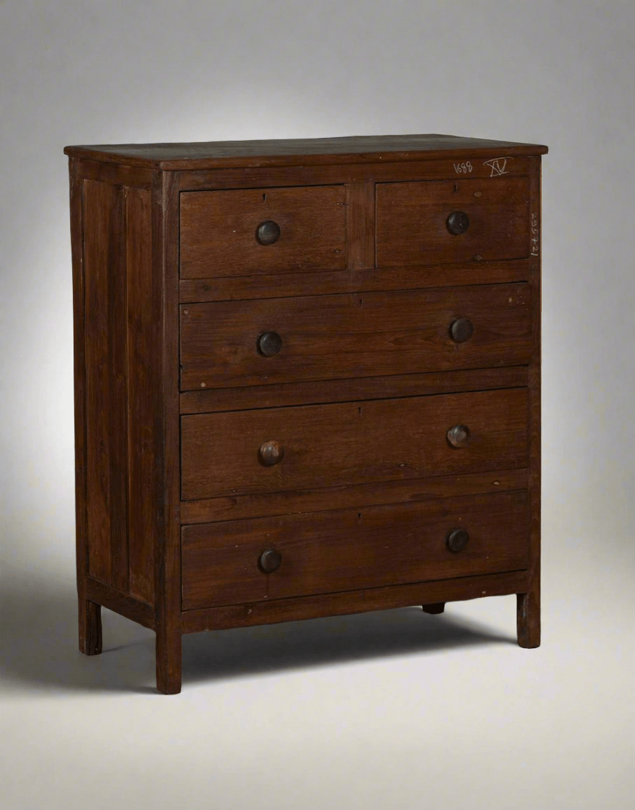 Wooden dresser with four drawers on a gray background