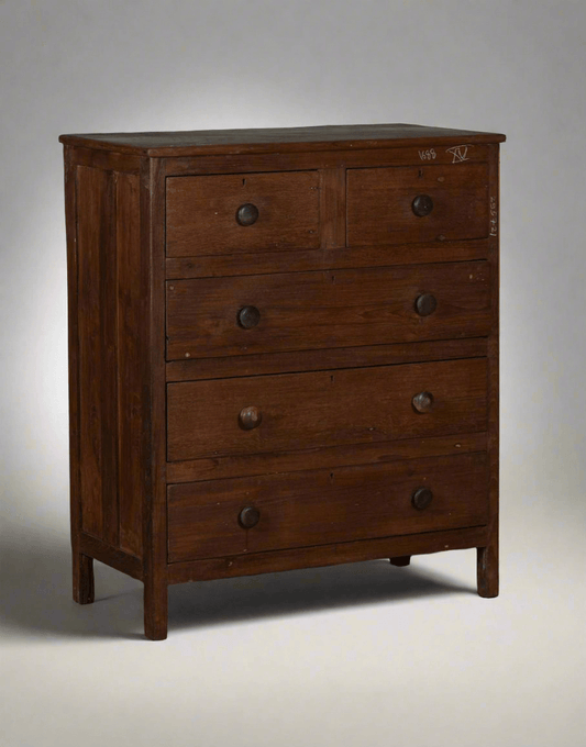 Wooden dresser with four drawers on a gray background