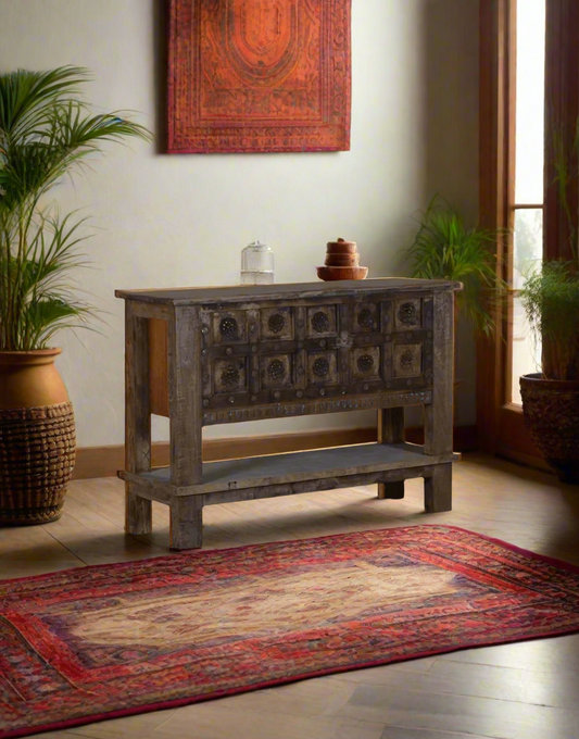 Wooden console table with decorative carvings in a minimalistic room.
