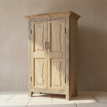 Vintage wooden cabinet with two doors in a storage or warehouse setting