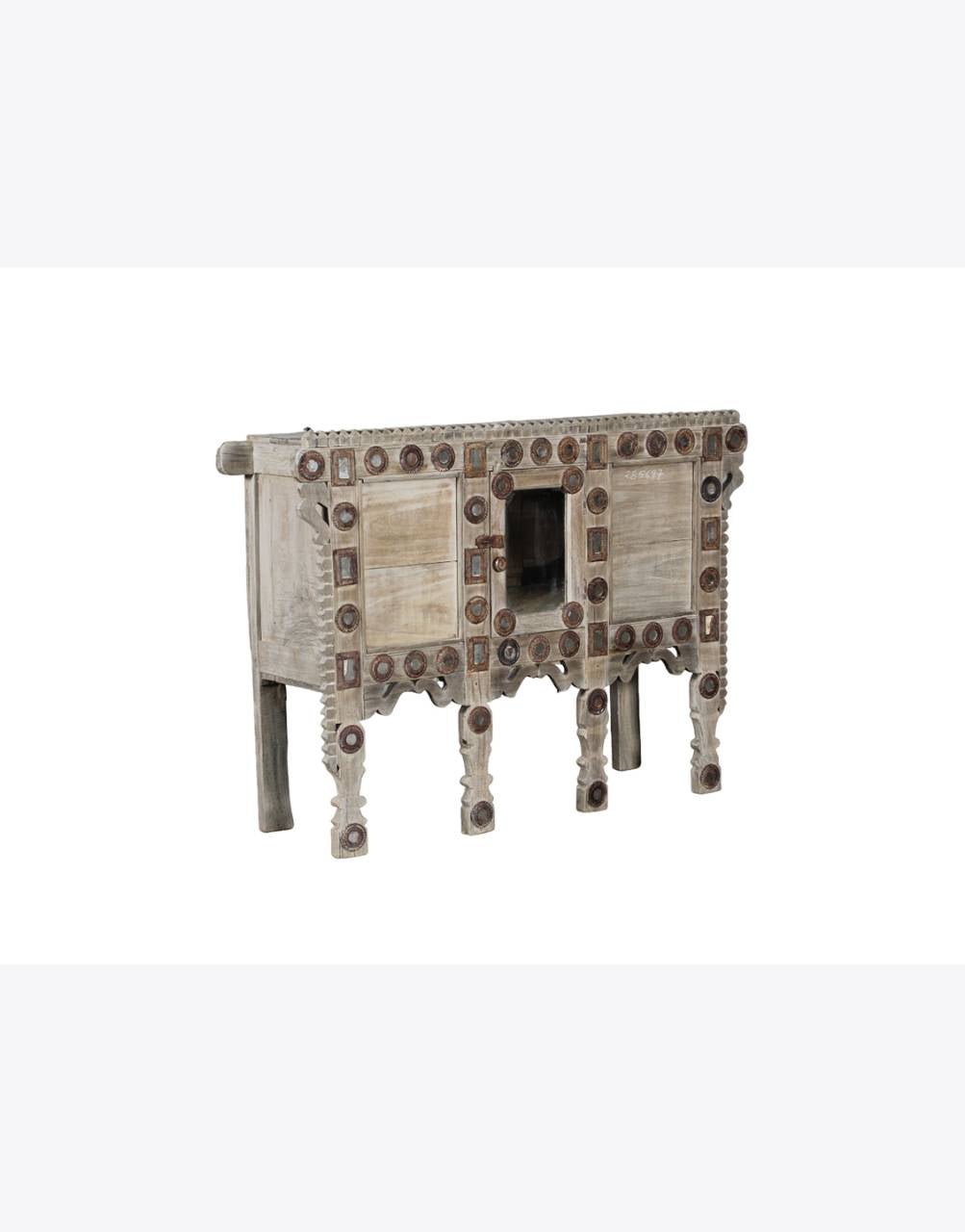 Decorative wooden cabinet with intricate carvings on a white background