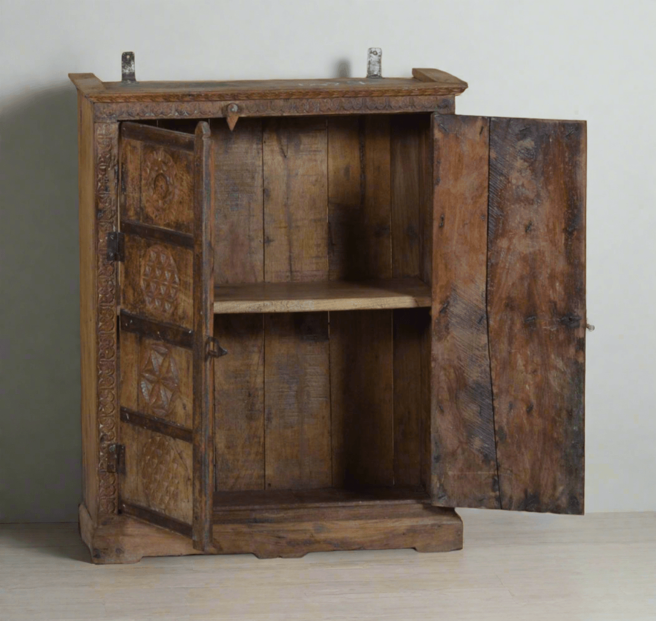 Vintage wooden cabinet with open doors on a plain background