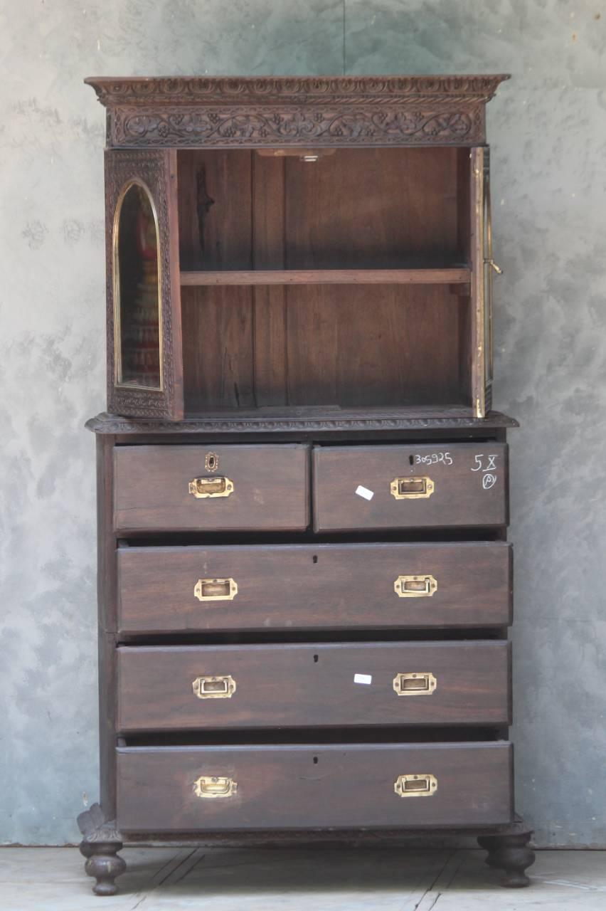 Antique wooden almirah with multiple drawers and mirror door against textured wall – Tesu Furniture & Seating