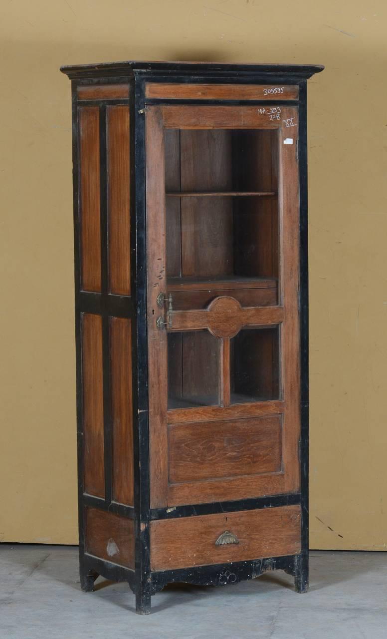 Wooden cabinet with black trim against a beige wall