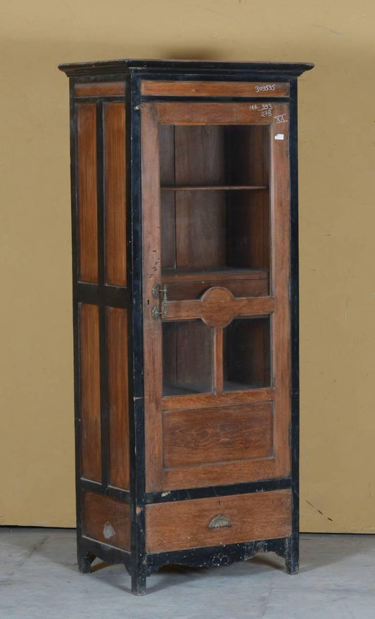 Wooden cabinet with black trim against a beige wall