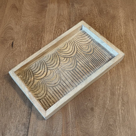 Wooden stamp block with a geometric pattern on a wooden surface