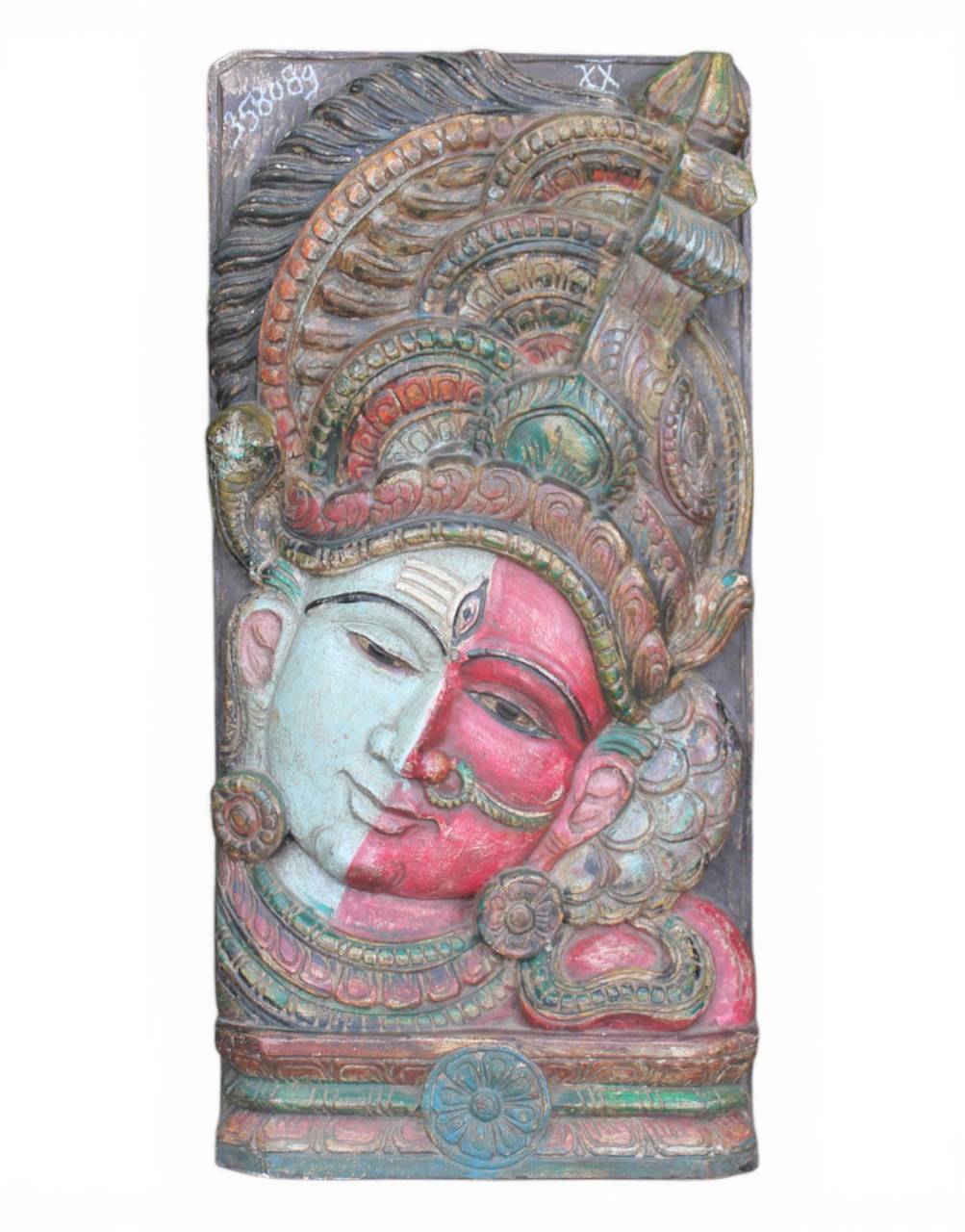 Decorative wall piece with a face design and intricate patterns on a white background