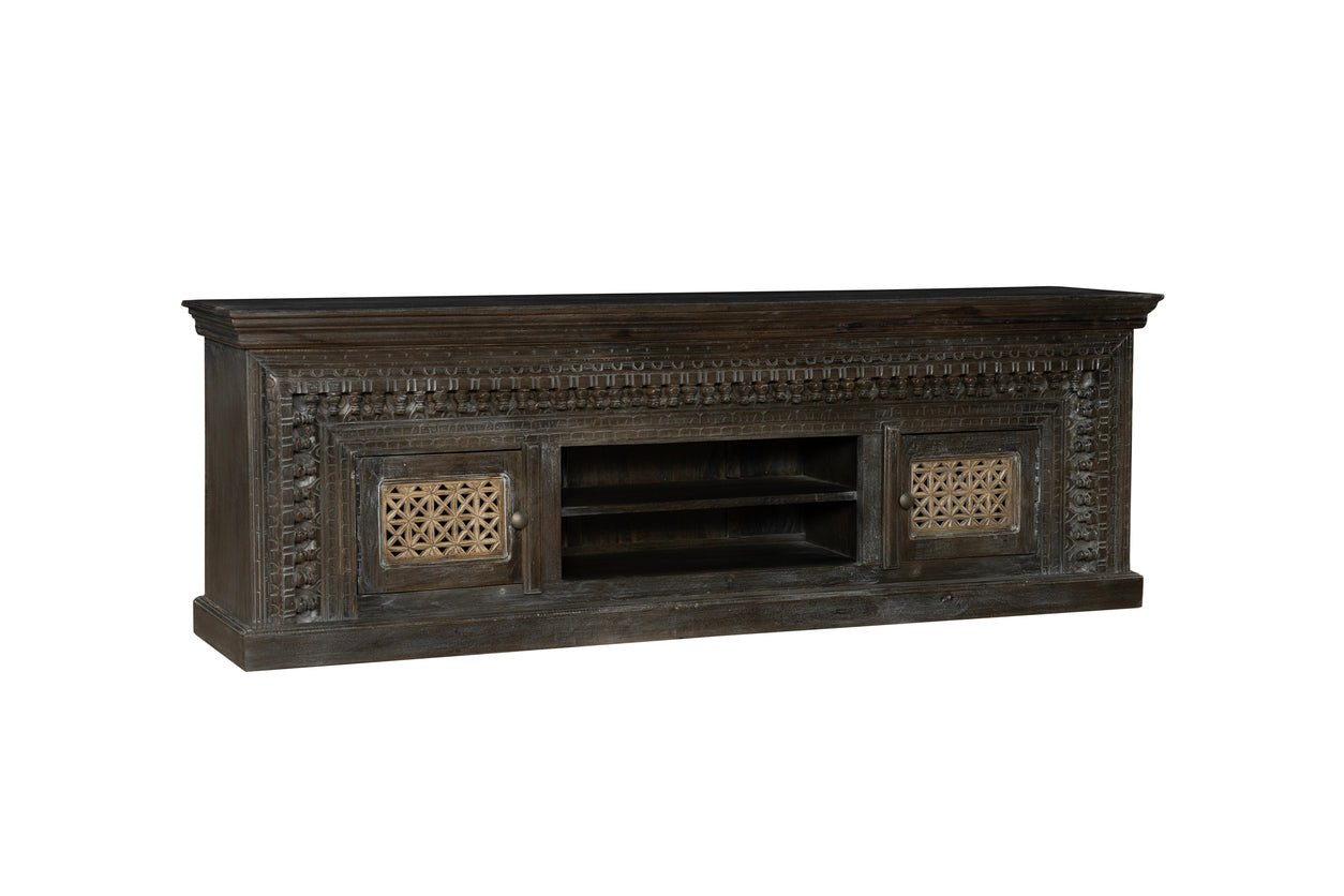 Dark wooden TV stand with intricate carvings on a white background