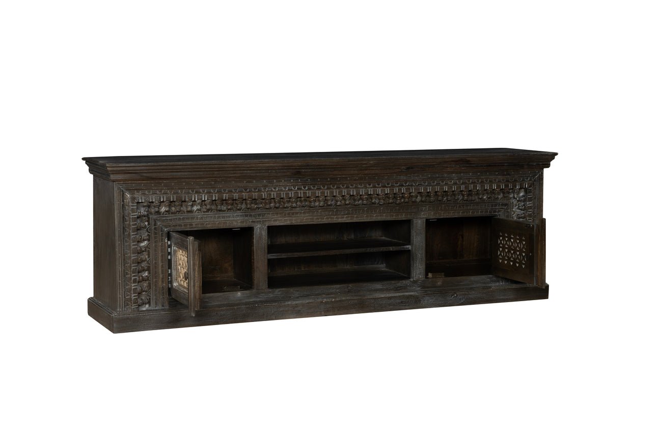 Dark wooden TV stand with intricate carvings on a white background