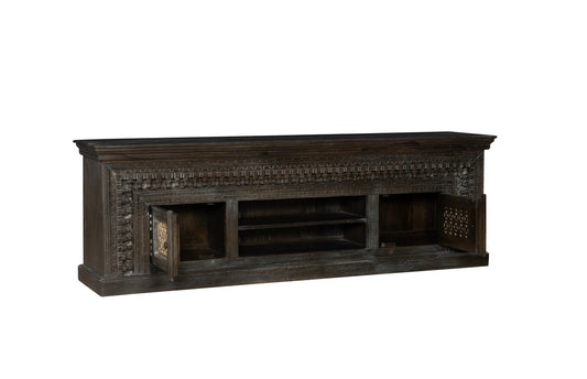 Dark wooden TV stand with intricate carvings on a white background