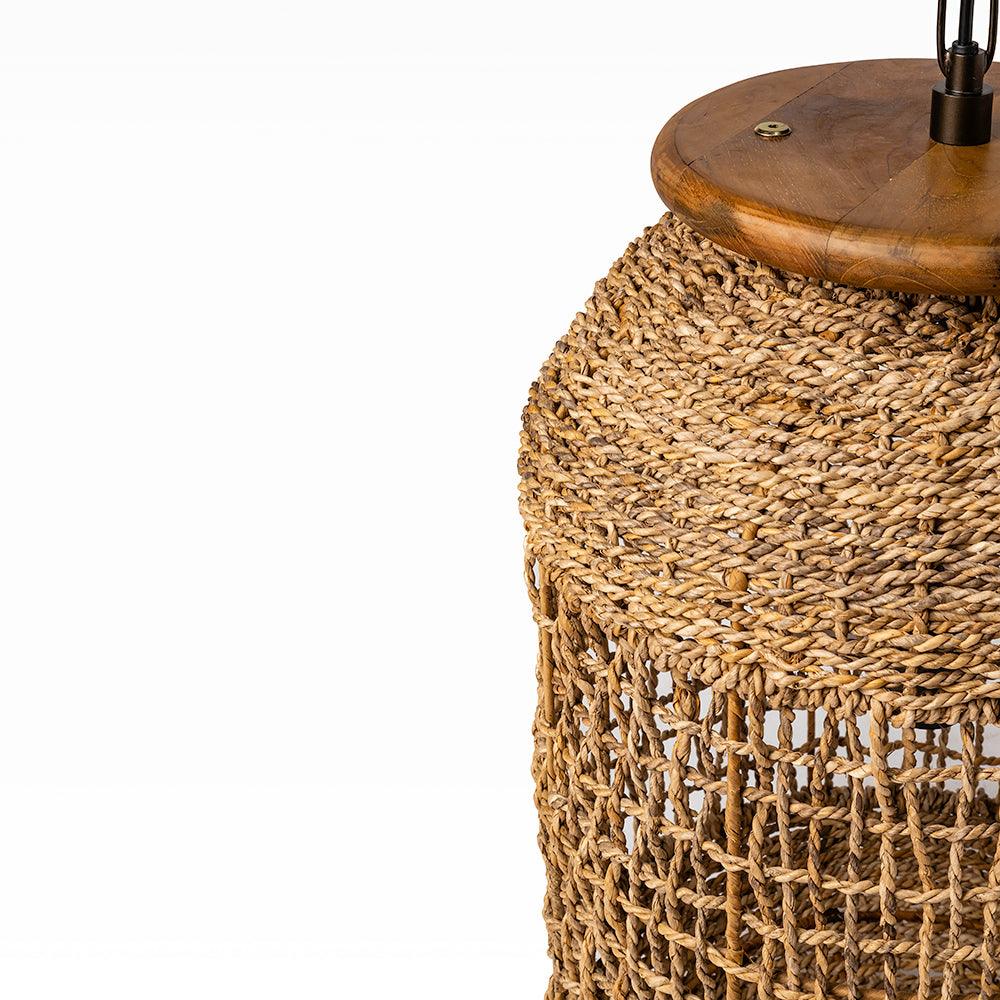 Woven rattan table lamp with wooden base on a white background