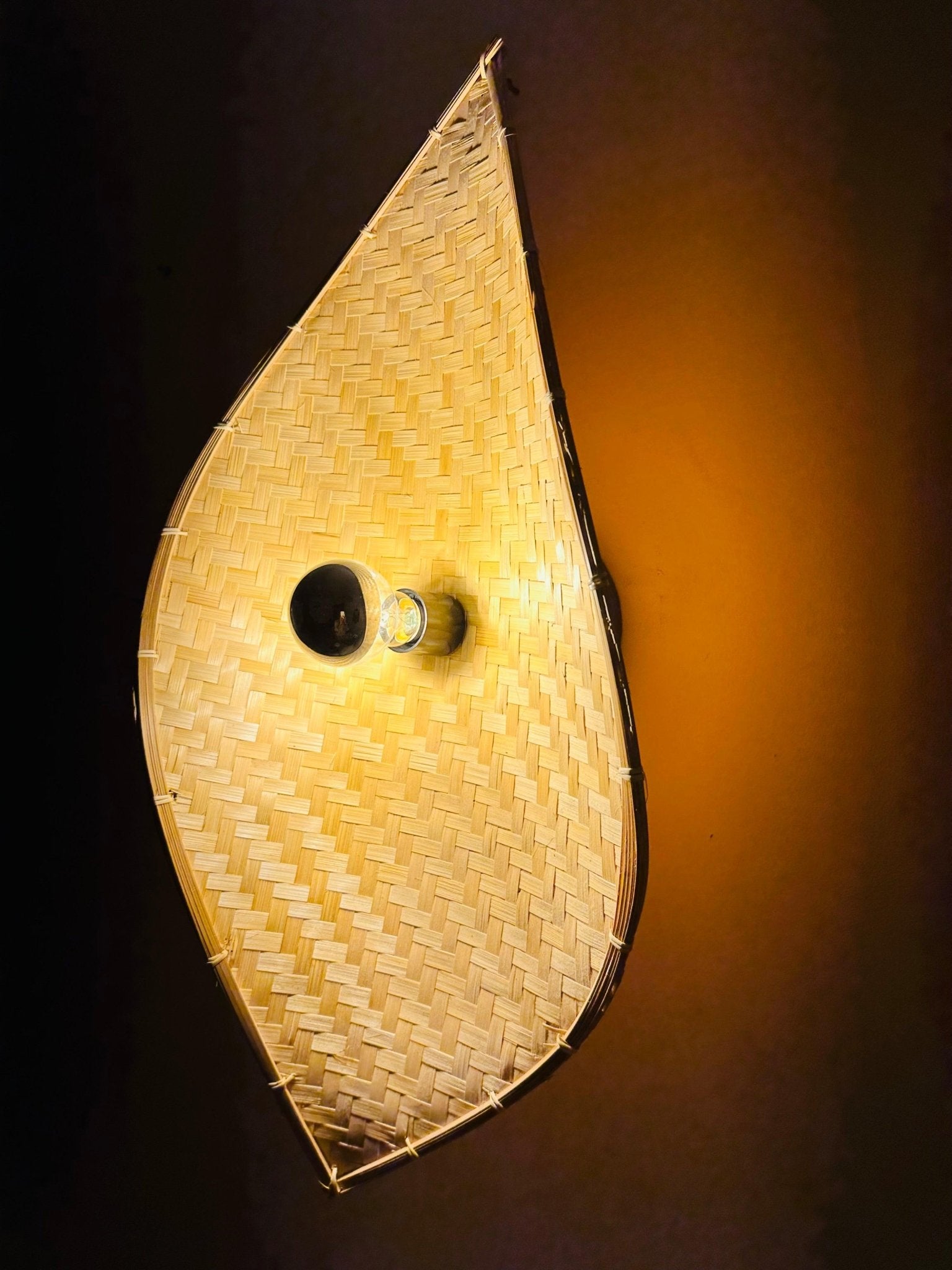 Close-up of bamboo curve wall light showing natural bamboo texture and weave – Tesu Lamps & Lighting