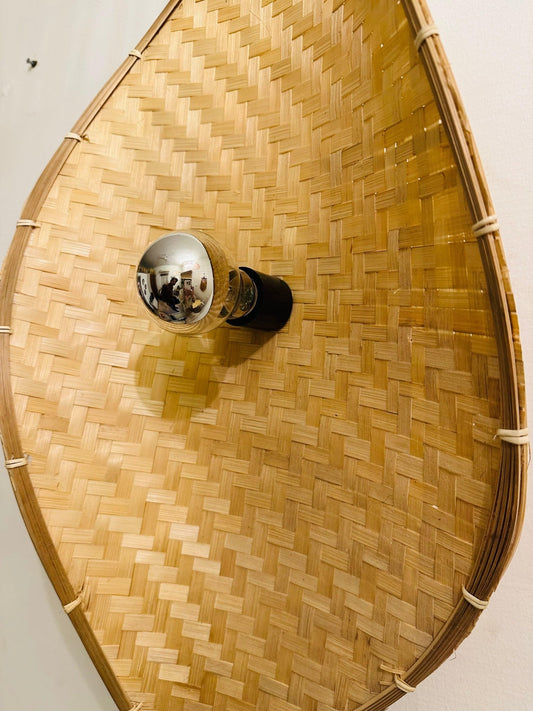 Handcrafted bamboo curve wall light with a sleek natural finish, casting a warm and cozy glow for stylish eco-friendly home décor.