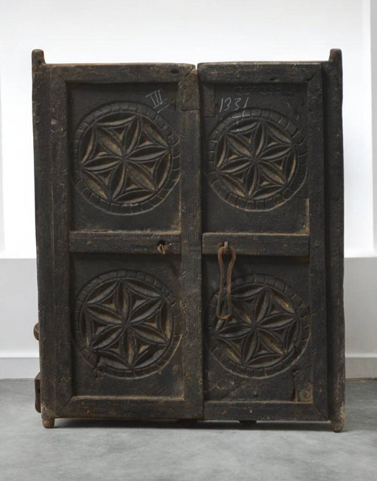 Vintage wooden chest with star patterns on a white background