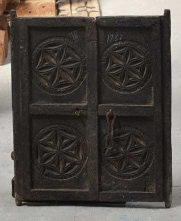 Vintage wooden printing block with star patterns on a gray background