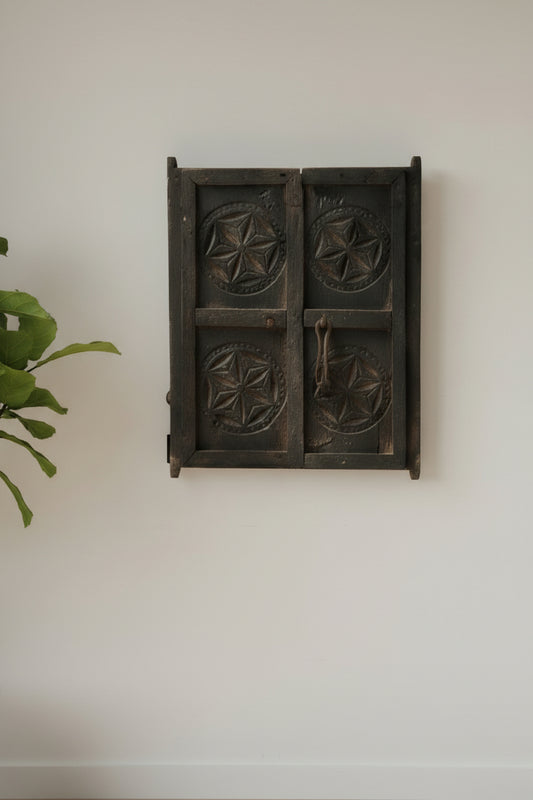 Vintage wooden printing block with star patterns on a gray background