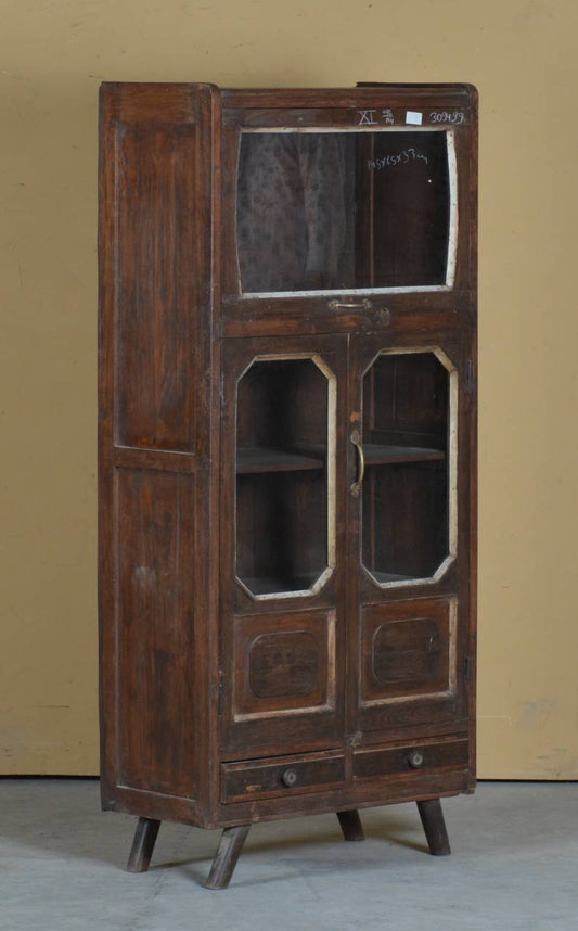 Vintage wooden cabinet with glass doors against a beige wall.