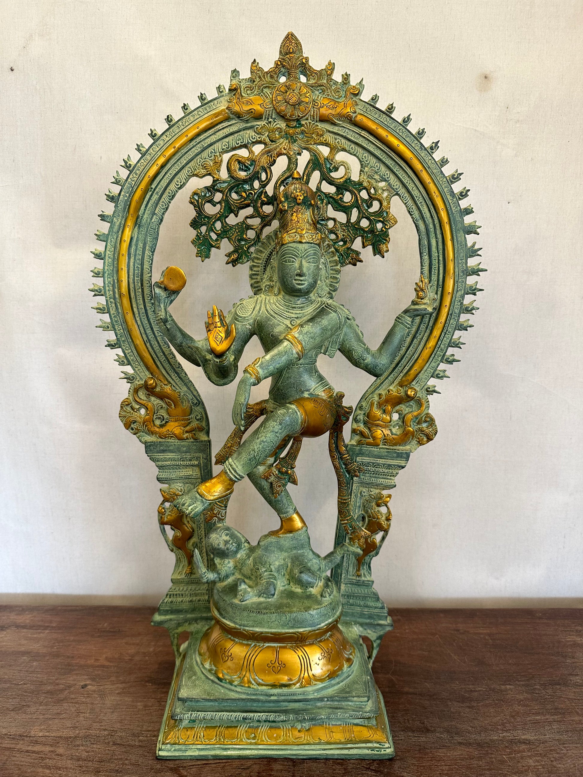 Decorative statue with green and gold colors on a white background