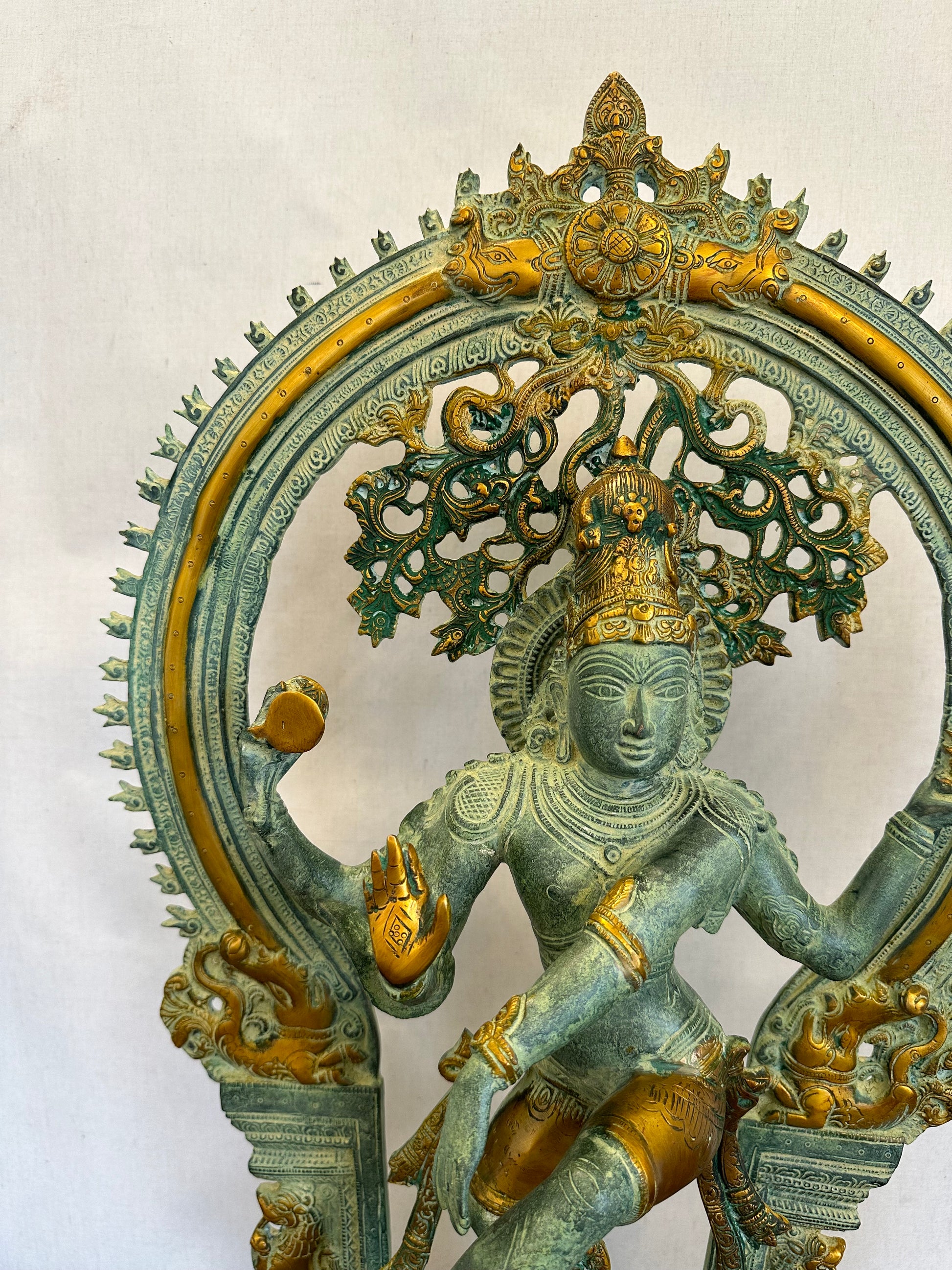 Decorative metal sculpture with intricate designs on a white background
