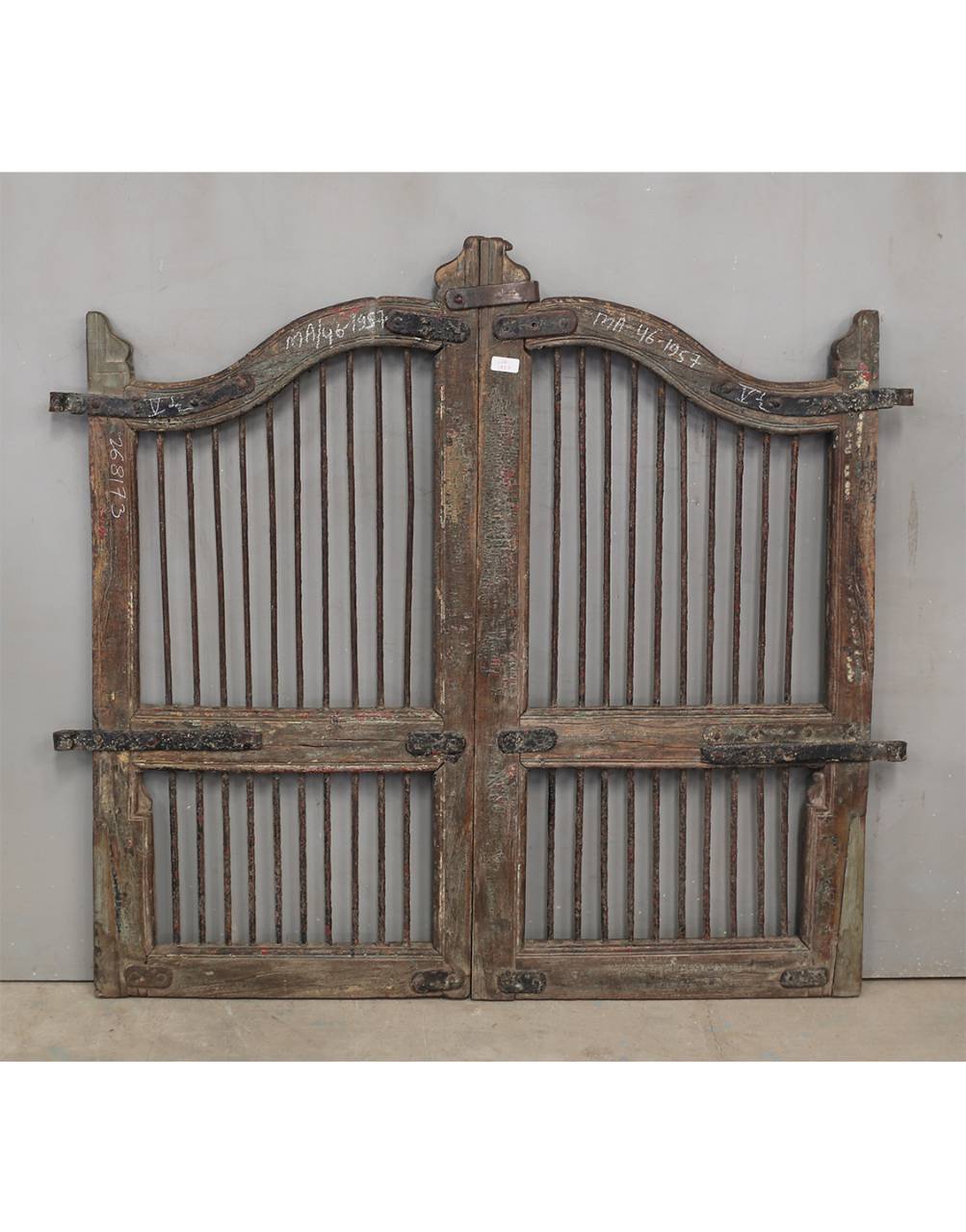 Pair of rustic wooden gates with metal bars 