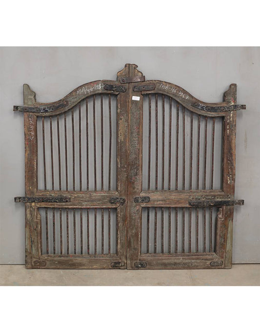 Pair of rustic wooden gates with metal bars 