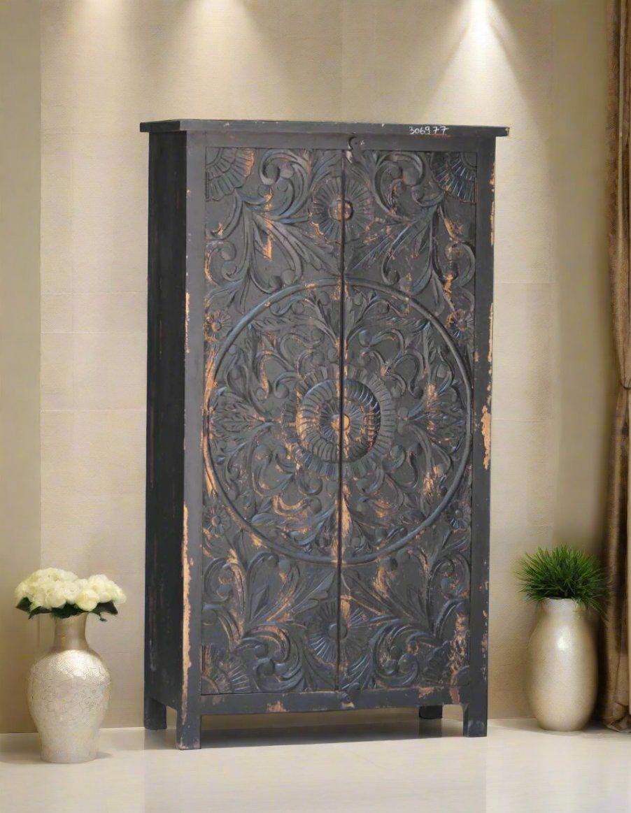 Decorative wooden cabinet with intricate carvings in a room setting.