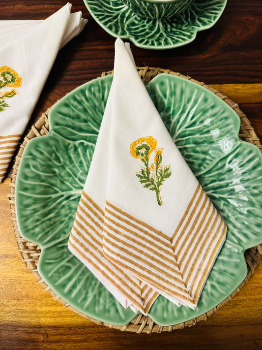 Napkin with floral design and striped pattern on a green plate