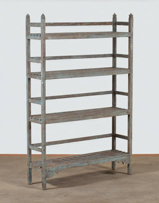 Wooden bookshelf with a distressed finish on a plain background