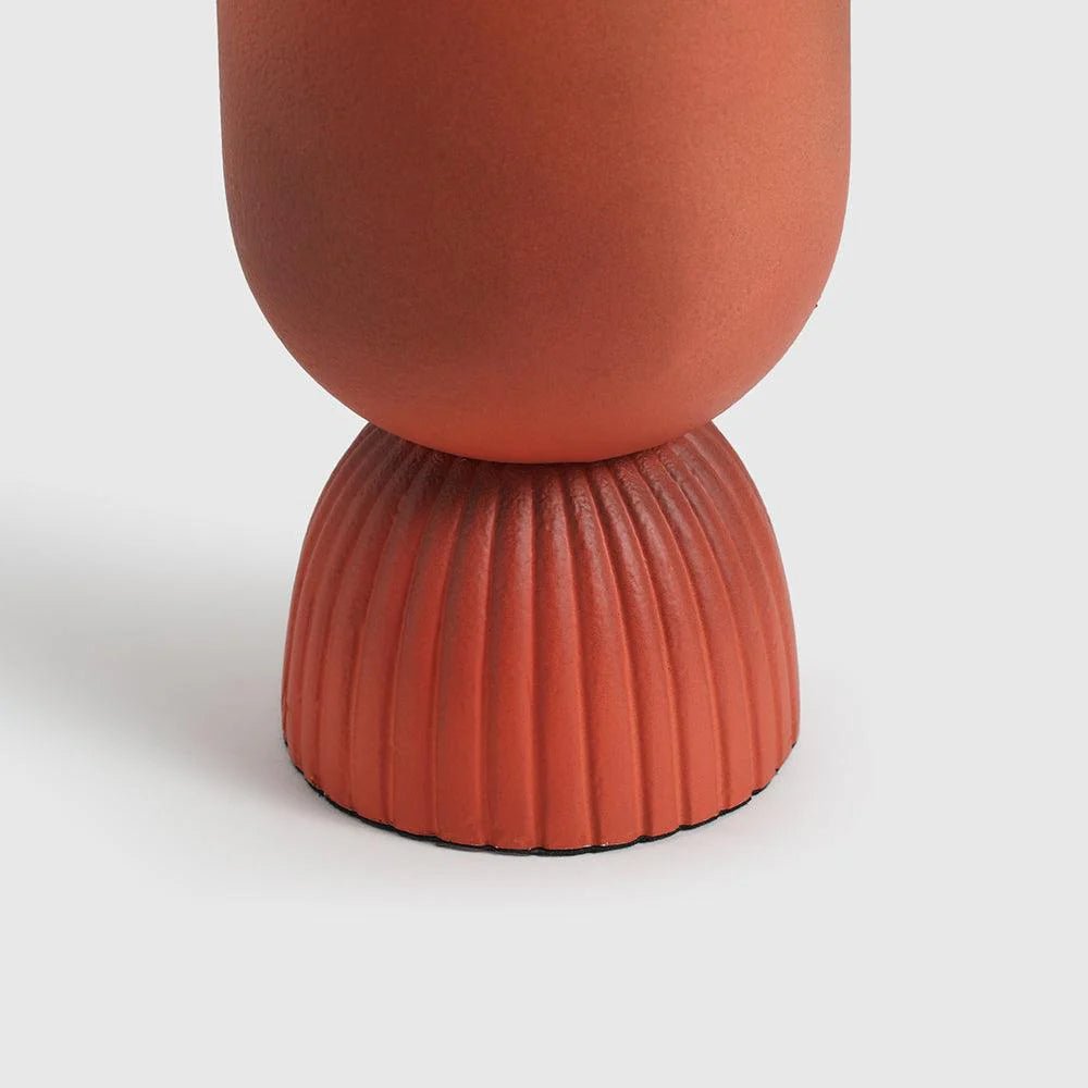 colored lamp with ribbed base on a white background