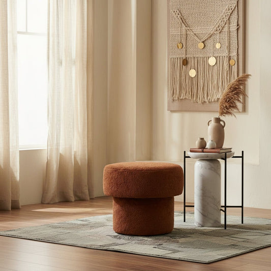 Brown textured ottoman on a patterned rug with a neutral background